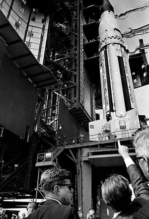 President John F. Kennedy, left, and Dr. Wernher von Braun point to the Saturn booster on its stand in Cape Canaveral, Fla., as the president gets a briefing on the lunar program, Nov. 16, 1963. Von Braun is director of Marshall Space Flight Center. (AP Photo)