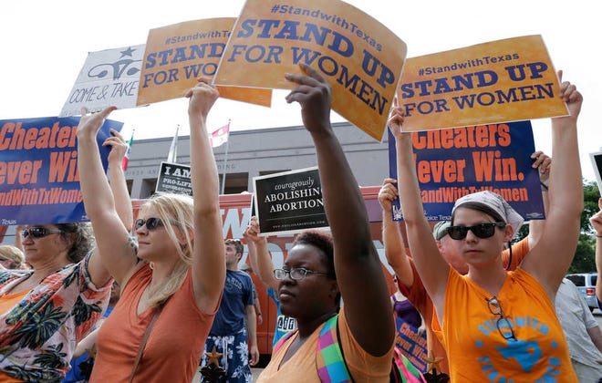 Opponents and supporters of an abortion bill rally near a news conference July 9 outside the Texas Capitol in Austin. A sharply divided Supreme Court on Tuesday allowed Texas to continue enforcing abortion restrictions.