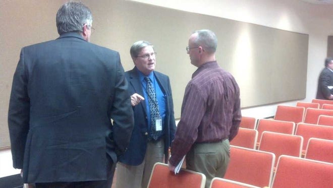 Municipal Court Administrative Judge Vic Miller, center, talked Tuesday night after the Topeka City Council meeting with Mike Sly, right, who requested the council reimpose prosecution of those accused of dring on a suspended license.