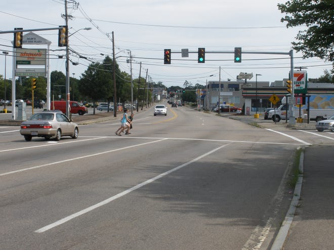 Children crossing Belmont Street at West Street and the West Side Plaza look for a break in traffic and then must run across against the light because there is no pedestrian signal there. (Courtesy: Old Colony Planning Council)