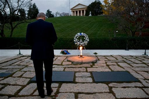 Attorney General Eric Holder pays his respects at the grave of John F. Kennedy at Arlington National Cemetery on Friday, Nov. 22, 2013, on the 50th anniversary of Kennedy's death. Holder has been visiting the grave since his youth.