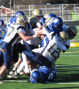 The Golden Eagle defense drops a Comet running back.