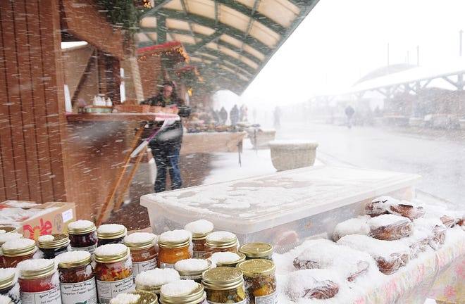 Snow covers goods for sale at the opening of the Kerstmarkt on Saturday afternoon at the Eighth Street Marketplace. Dennis R.J. Geppert/Sentinel Staff