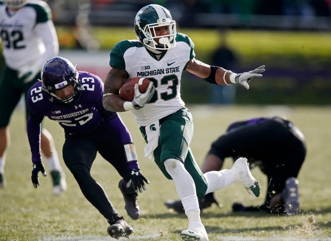 Michigan State running back Jeremy Langford (33) advances against Northwestern on a touchdown scoring run during the second half on Saturday in Evanston, Ill. (AP Photo/Andrew A. Nelles)