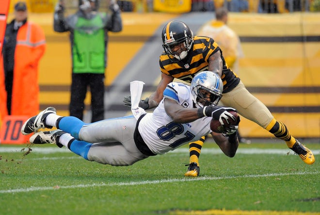 Detroit Lions wide receiver Calvin Johnson (81) dives for a touchdown after making a catch in front of Pittsburgh Steelers cornerback Ike Taylor (24) last Sunday in Pittsburgh. (AP Photo/Don Wright)