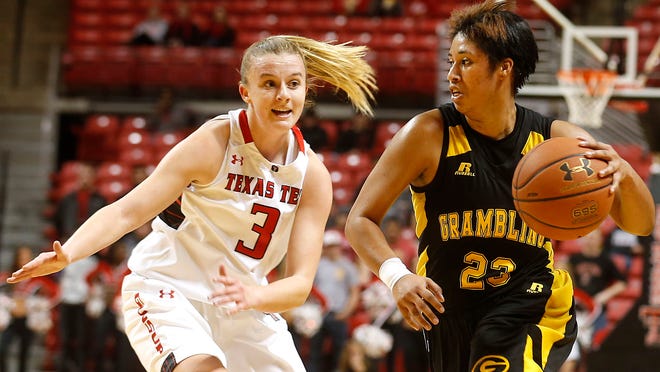 Grambling State's Joanna Miller looks to get by Texas Tech's Minta Spears during their game on Saturday in Lubbock. (Stephen Spillman/AJ Media)