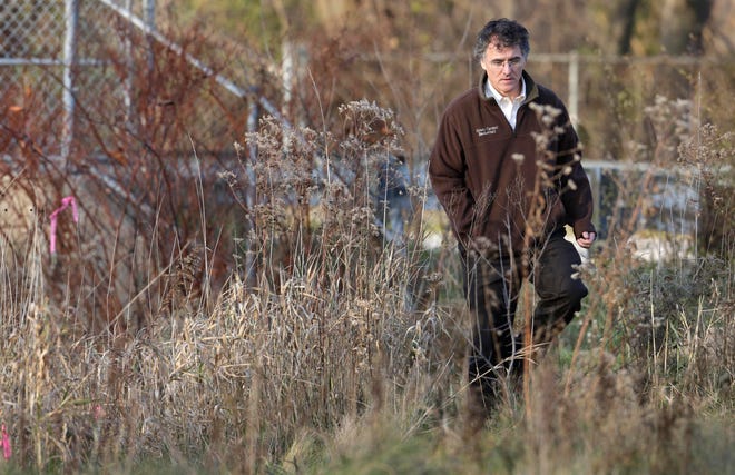 Cook County Sheriff Tom Dart walks at the site where a 14-year-old girl was raped in 1991 in Robbins, Ill., as she was walking home from basketball practice.