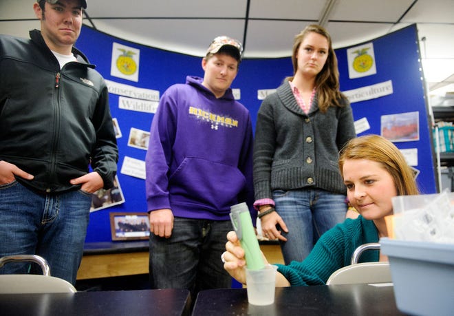 Columbia FFA team members, from left, Carson Banks, Austin Wallace, Isabelle Mitchell and Kira Kirk demonstrate their skills by measuring the level of acidity in a sample of water Thursday at the Columbia Area Career Center. The team was crowned national champions in the Environmental and Natural Resources Career Development Event at the national FFA competition earlier this month.
