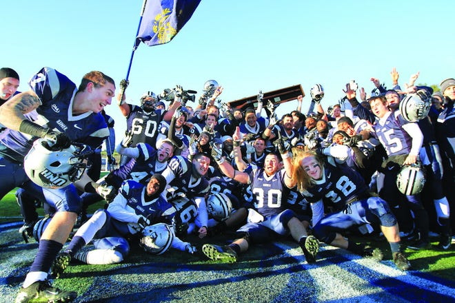 The University of New Hampshire football team revels in its 24-3 win over Maine with the Brice-Cowell Musket on Saturday at Cowell Stadium.
