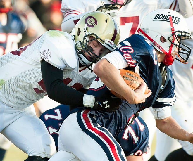 John Carden/Portsmouth Herald photo

Portsmouth's Jack Young, left, tackles Plymouth quarterback Collin Sullivan during Saturday's Division II championship game at Plymouth.