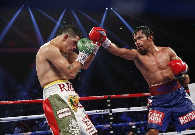 Vincent Yu Associated Press Manny Pacquiao (right) punches Brandon Rios during their WBO international welterweight title fight Sunday in Macau. Pacquiao defeated Rios by unanimous decision to take the title and return to his winning ways.