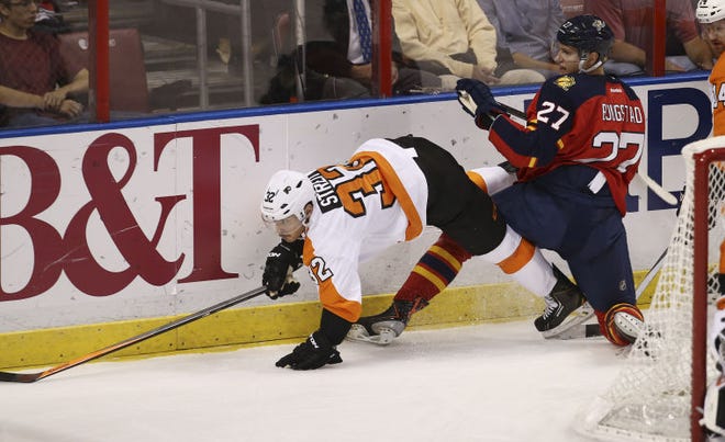 The Panthers' Nick Bjugstad (right) upends Philadephia's Mark Streit as they battle for the puck.