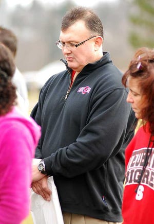 Steubenville City Schools Superintendent Michael McVey prays during a rally Monday. McVey was charged with two counts of obstructing justice, and single counts of falsification and tampering with evidence in the rape convictions of two Steubenville high school football players.  Michael D. McElwain Steubenville Herald-Star