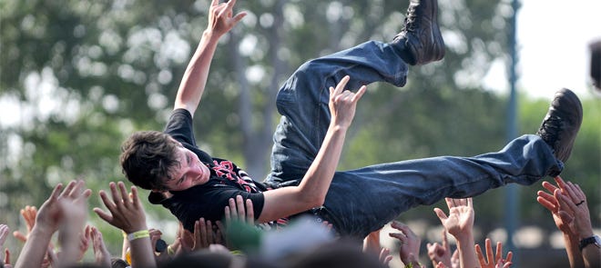 During the band Buckcherry's performance an audience member crowd surfs toward the stage. Day two of Monster Energy's Welcome to Rockville concert was held at Metropolitan Park on Sunday, April 28, 2013, in Jacksonville, Florida. See the photo gallery links on the right hand side of the PC version of this story for more coverage.