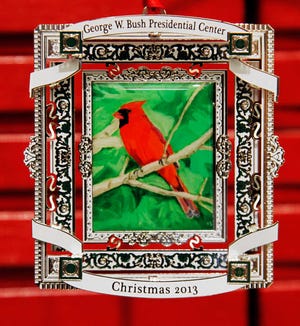 This Nov. 21, 2013 photo shows a 2013 commemorative Christmas ornament of a cardinal that Former President George W. Bush painted in Dallas, Texas. The ornament is now for sale at the Bush Presidential Center. (AP Photo/The Dallas Morning News, David Woo) MANDATORY CREDIT; MAGS OUT; TV OUT; INTERNET USE BY AP MEMBERS ONLY; NO SALES