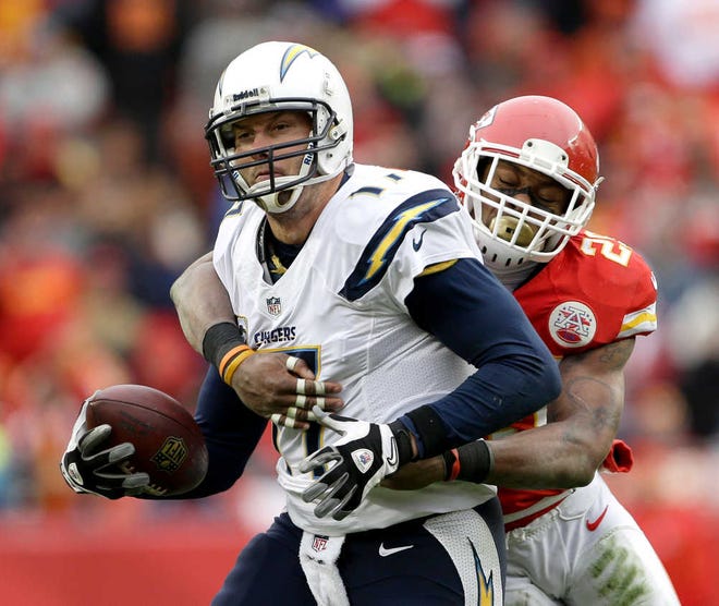 San Diego Chargers quarterback Philip Rivers (17) is sacked by Kansas City Chiefs strong safety Eric Berry (29) during the second half of an NFL football game on Sunday, Nov. 24, 2013, in Kansas City, Mo. The Chargers won the game 41-38. (AP Photo/Charlie Riedel)