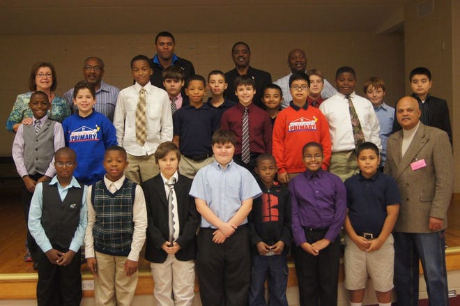 The Young Men of Character program at Pecan Grove Primary School stand with mentors Richard Brown, Ed Price, Tim Riley, Claxton Bernard, Marc Peters, and teacher Rhonda Lamendola.