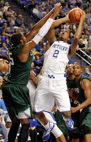 Kentucky's Aaron Harrison (2) shoots under pressure from Cleveland State's Jon Harris during the second half of an NCAA college basketball game, Monday, Nov. 25, 2013, in Lexington, Ky. Kentucky won 68-61. (AP Photo/James Crisp)