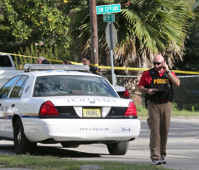 Members of the Ocala Police Department investigate a fatal shooting in the intersection of Southwest 5th Street and Southwest 12th Avenue in Ocala, Fla. on Saturday, Nov. 23, 2013. (Star-Banner Photo/Bruce Ackerman) 2013.