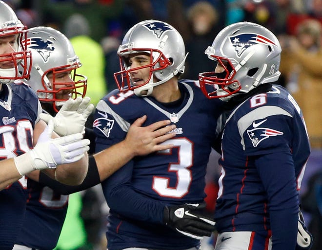 New England Patriots kicker Stephen Gostkowski, center, is congratulated after his game-winning fieldgoal against the Denver Broncos in overtime of Sunday's game in Foxboro. The Patriots won 34-31.
