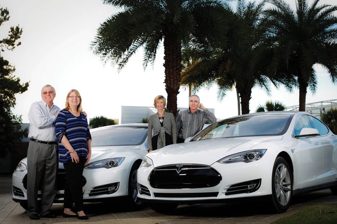 From left, Bob Fulton and his wife, Betsy Styron, and Ken and Linda McGurn with their Tesla electric cars.