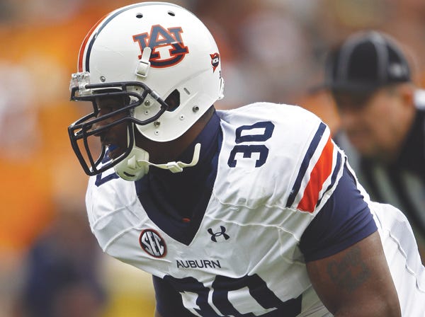 Auburn defensive lineman Dee Ford prepares for the snap during a game against Tennessee on Nov. 9. Ford and the Tigers take on Alabama in the Iron Bowl on Saturday. (Wade Payne | Associated Press)