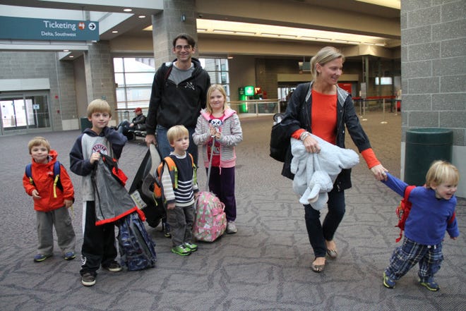 Ethan and Liana Meyers, of Cohasset, Mass., and their children head to Florida Wednesday morning from T.F. Green Airport in Warwick. From left, the children are Brody, 4; Tyler, 9; Bryce, 4; Tess, 9; and Cooper, 2.