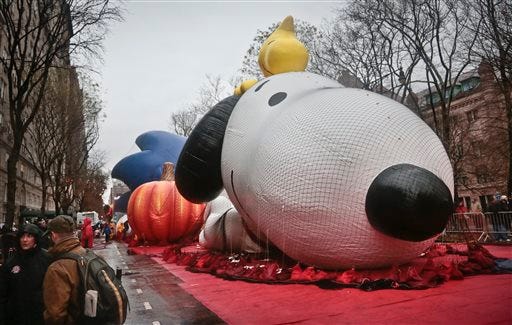 The Macy's Parade Snoopy balloon is partially inflated Wednesday in New York. The characters that glide between Manhattan's skyscrapers can't lift off if sustained winds exceed 23 mph and gusts top 34 mph. The New York Police Department, the National Weather Service and Macy's representatives will make a final determination in the morning.