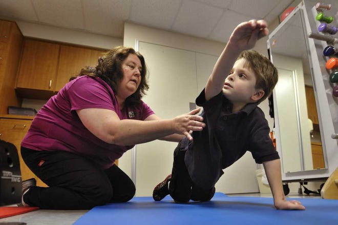 Ben Bowersox, 6, works with physical therapist Joanne Goulet at Wolfson Children's Rehabilitation Beaches Clinic.