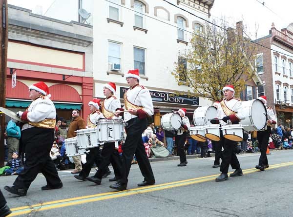 The Newton High School Marching Band performs on Spring Street in Newton during the 2012 Holiday Parade.