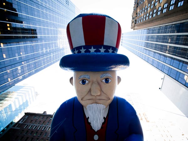 John Minchillo | ASSOCIATED PRESS
A giant Uncle Sam balloon is marched down Sixth Avenue on Thursday during the 87th Annual Macy’s Thanksgiving Day Parade in New York. After fears the balloons could be grounded if sustained winds exceeded 23 mph, Snoopy, Spider-Man and the rest of the iconic balloons received the all-clear from the New York Police Department to fly between Manhattan skyscrapers on Thursday.