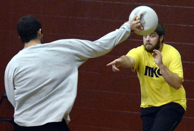 BRIAN D. SANDERFORD TIMES RECORD / Phillip Smith, right, keeps his eyes on the ball as Jacob Wyatt fires a shot at him during Dodging for Dystrophy at the University of Arkansas at Fort Smith on Tuesday, Nov. 26, 2013. More than 70 UAFS students participated in the MDA fundraiser hosted by Kappa Alpha Order.