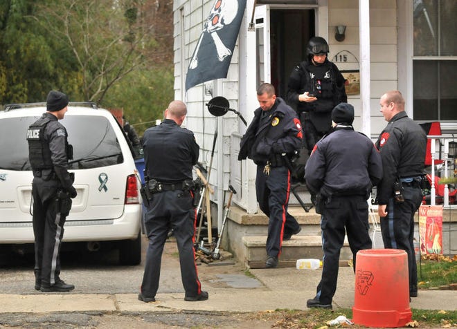 Mount Holly police exit a home at 115 Clover Street where a drug raid took place on Tuesday morning.