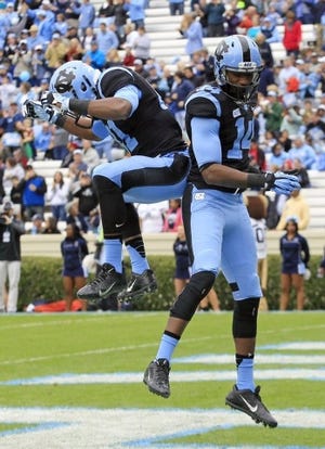 North Carolina's Quinshad Davis (14) celebrates his touchdown with Roy Smith (81) during the first quarter. The Tar Heels defeated the Monarchs, 80-20, at Kenan Stadium in Chapel Hill, N.C., on Saturday, Nov. 23, 2013. (Chris Seward/Raleigh News & Observer/MCT)