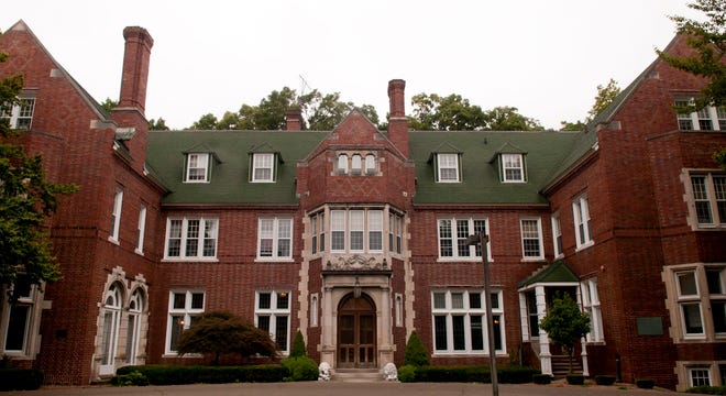 Holmdene Hall, built in 1908, is now a a Tudor-style administration and faculty office building at Aquinas College. Aquinas College plans to provide a hotel room for a student who wouldn't have had a place to stay when its campus closes for the holiday break. The Associated Press