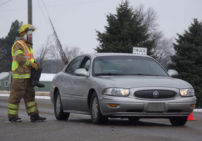 Andrew Hulsman, an Overisel Township Fire Department member, collects money on Friday, Nov. 29, at the intersection of 48th Street and 142nd Avenue for the annual ìGive Hunger the Bootî campaign to benefit Hungry for Christ. The group distributes meals to local food pantries and hot meal kitchens in Allegan County, helping 1,000 local families a week. Jim Hayden/Sentinel staff