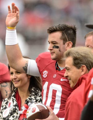 Alabama quarterback AJ McCarron (10) waves to the crowd with mother Dee Dee Bonner left, and Alabama head coach Nick Saban at right, during Alabama Senior Day celebration before an NCAA football game against Chattanooga, Saturday, Nov. 23, 2013, at Bryant-Denny Stadium in Tuscaloosa, Alabama. (AP Photo/AL.com, Vasha Hunt) MAGS OUT