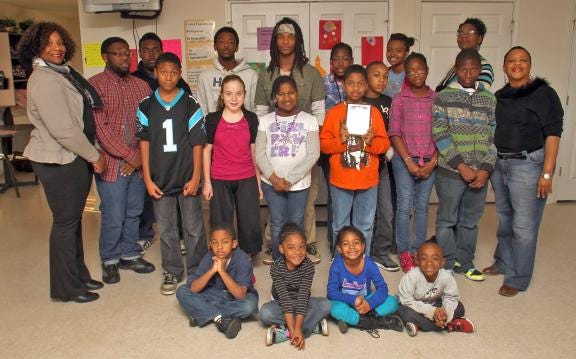 Because of their acts of kindness, the children in the after school program at Kings Row Apartments in Kings Mountain have received a Carl Carpenter Gold Heart Award from the family of Dick Palmer. Suzette Ross, program coordinator, was also surprised with a separate award, because of her leadership and dedication to the children.