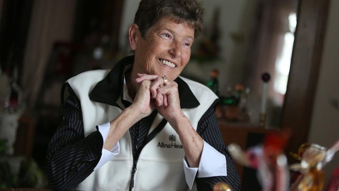 Susan Tretter smiles at her Montrose, Minn., home. Tretter needed a heart pump to survive, and the pump apparently allowed her heart enough rest to heal to a point where the pump could be removed. Such cases are rare, but researchers hope to develop new pumps as step toward making that outcome more common.