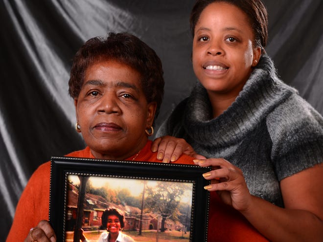 Sharon Wilkins was killed on Nov. 13, 2005, and found in the yard of a residence in Spartanburg.
Her sister, Patricia Manigan, left, and her daughter, Latisha Manigan, right, hold a photograph of Wilkins. The family hopes the cold case will be solved so they can have closure.