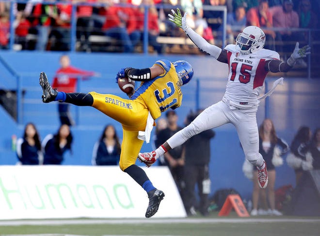 San Jose State linebacker Keith Smith (31) intercepts a Fresno State quarterback Derek Carr pass intended for wide receiver Davante Adams (15) during the second half of an NCAA college football game on Friday, Nov. 29, 2013, in San Jose, Calif. San Jose State won 62-52. (AP Photo/Tony Avelar)
