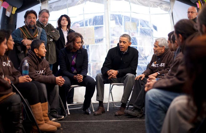 President Barack Obama and first lady Michelle Obama visit Friday with individuals taking part in Fast for Families on the National Mall in Washington. Obama met with the group who are fasting on behalf of immigration reform.