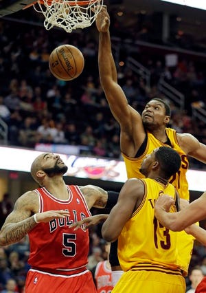 The Cavaliers' Andrew Bynum dunks on the Bulls' Carlos Boozer during the first quarter Saturday in Cleveland. Bynum scored 20 points in a 97-93 win.