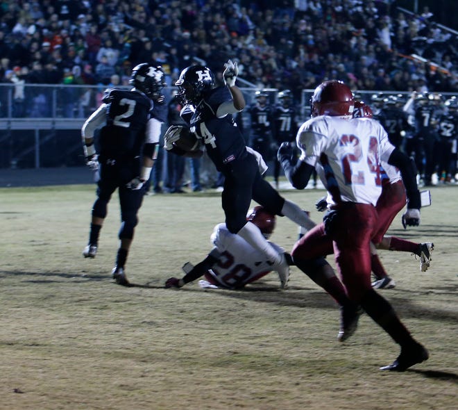 Havelock’s Derrell Scott leaps into the end zone on a 4-yard touchdown run Friday in a 48-2 win over North Forsyth.