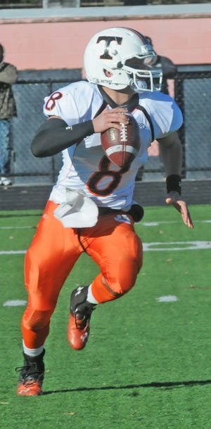 Taunton High quarterback Kyle Maderia runs for extra yardage in Thursday's Thanksgiving Day game against Coyle-Cassidy at Taunton High School.