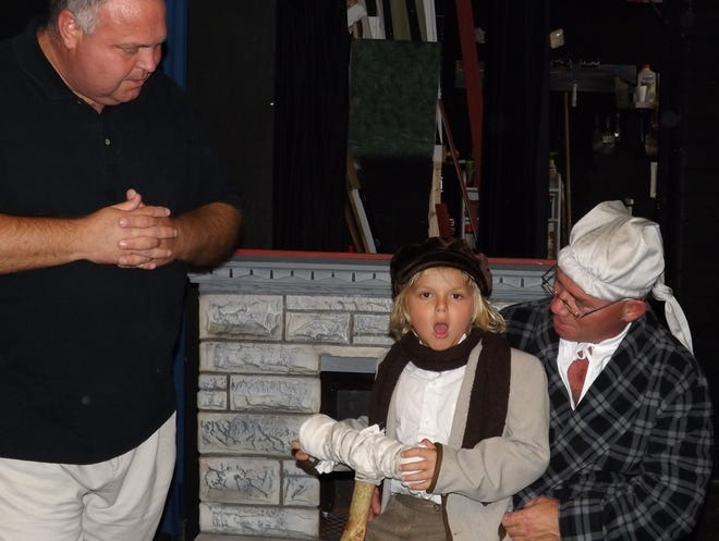 (L to R) Dan Blazi directs Sam Hillier, 6, and Larry Schnablel during a rehearsal for a Christmas Carol at the Little Theater in New Smyrna Beach. Photo by Taylor Ashley.