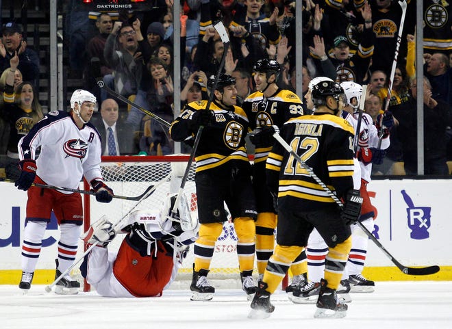 Milan Lucic, left, celebrates with Zdeno Chara and Jarome Iginla after scoring a first-period goal during the Bruins' 3-1 win over the Blue Jackets on Saturday night at the Garden.