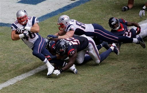 New England Patriots' James Develin (46) scores a touchdown against the Houston Texans during the third quarter of an NFL football game Sunday, Dec. 1, 2013, in Houston.