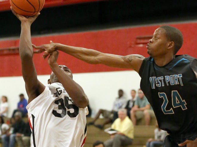 Dunnellon's Andre Hairston (35) drives to the basket as West Port's Nykey Boone (24) defends him during a basketball game at Dunnellon High School in Dunnellon, Fla. on Tuesday, Dec. 3, 2013.
