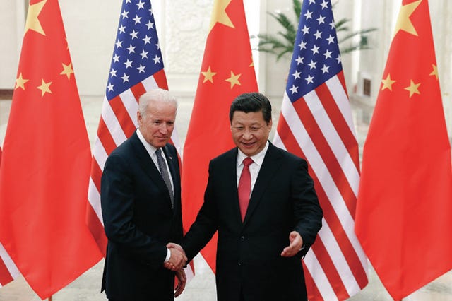 Chinese President Xi Jinping, right, shakes hands with U.S Vice President Joe Biden, left, as they pose for photos at the Great Hall of the People in Beijing, China, Wednesday, Dec. 4, 2013. AP Photo/Lintao Zhang, Pool